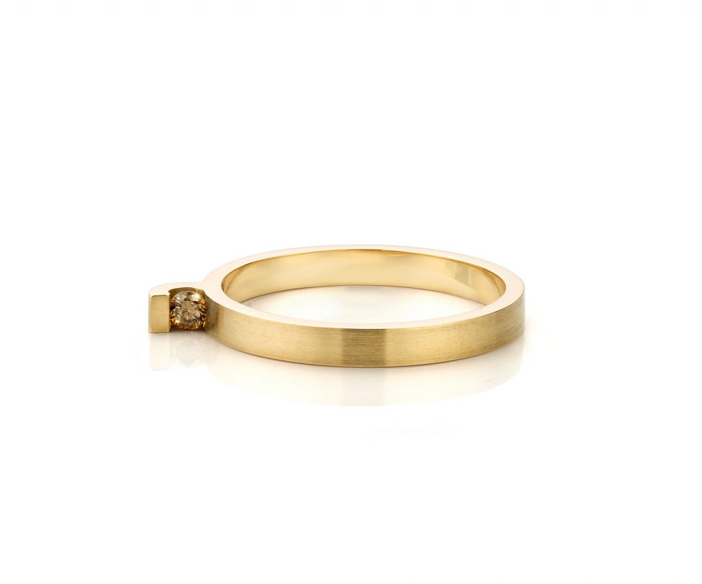 On the side, ring small with brown diamond